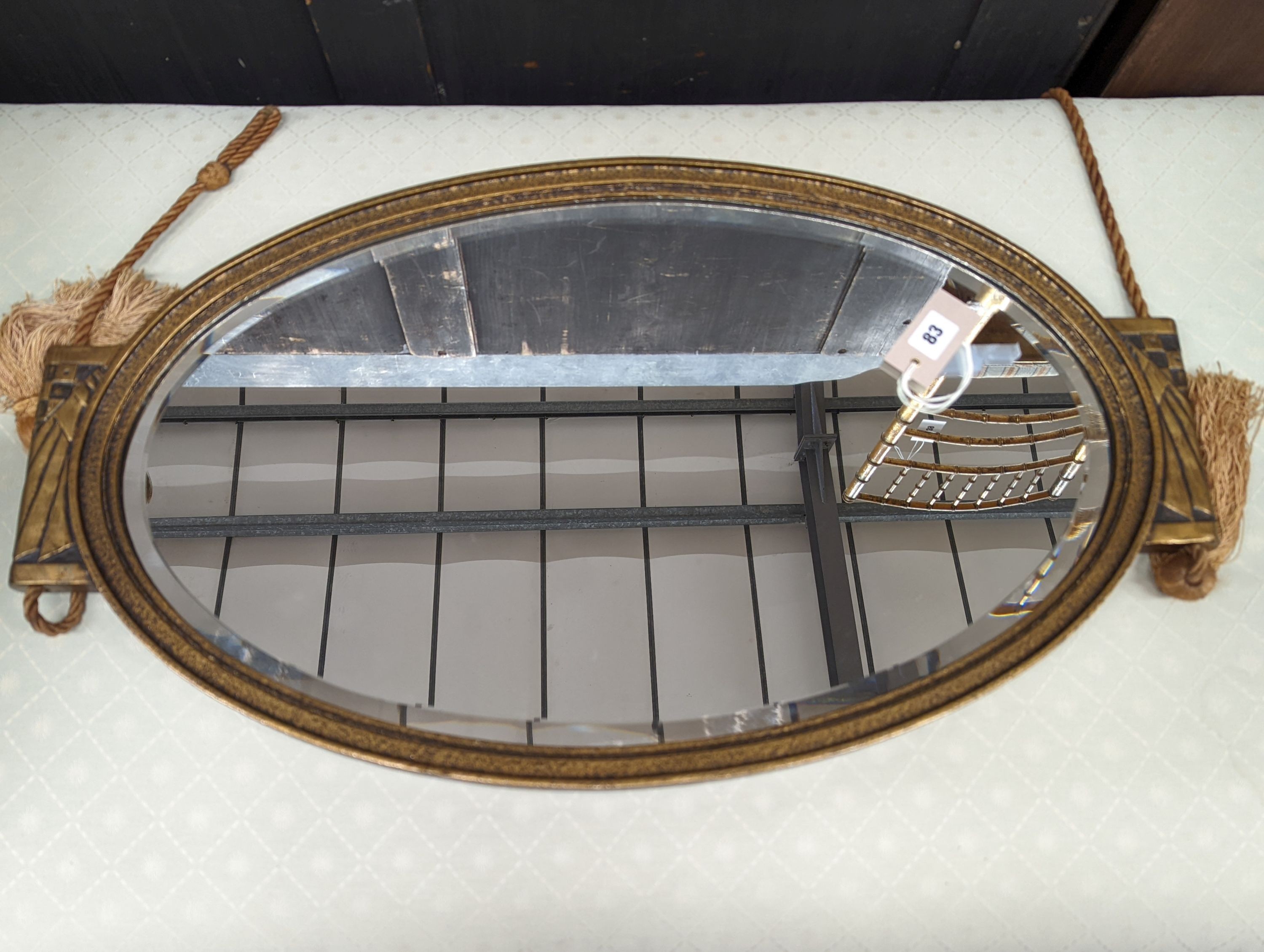 An Art Deco style oval wall mirror, width 74cm, height 43cm